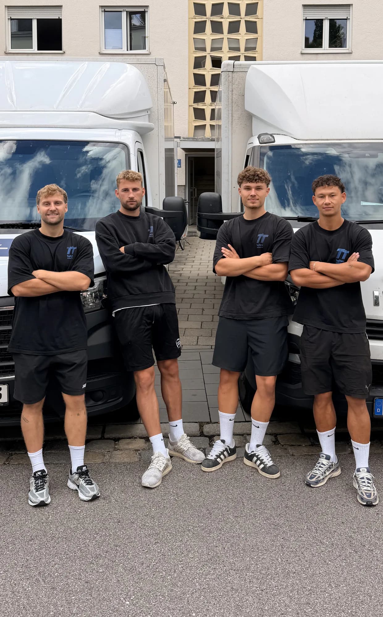 Vier Mitarbeiter von TopTrans Regensburg vor den Umzugs-LKW